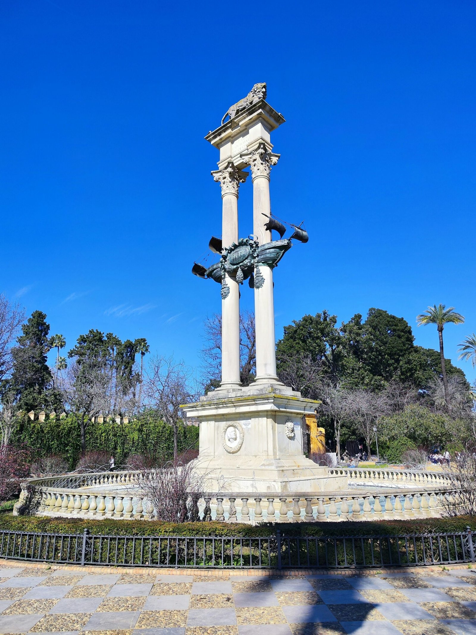 a statue of a horse on a pedestal in a park